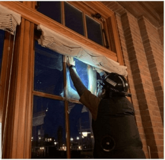Installed anti-shatter films on window glass in phases